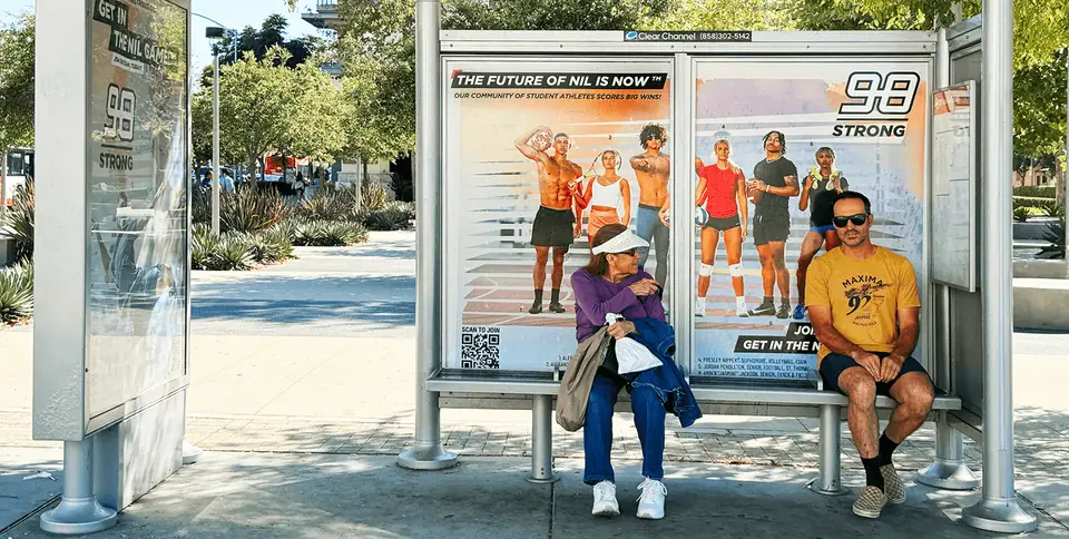 Strong98 billboard in a bus shelter: athlete photography with the new logo and bold typography